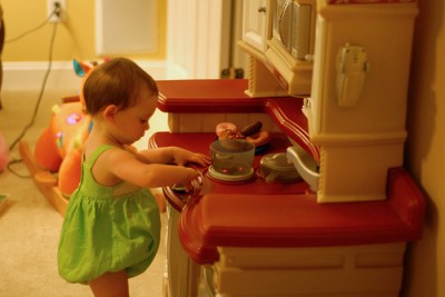 Toddler in play kitchen