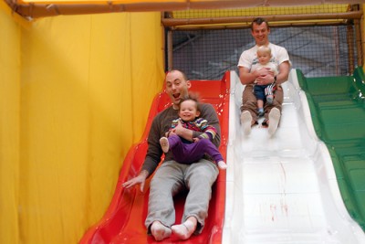 Dads and kids going down slide